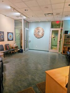 USE waiting room - Mammoth Hills Coaching and Wellness, LLC A cream and teal waiting room is softly lit and depicts chakra images on the walls